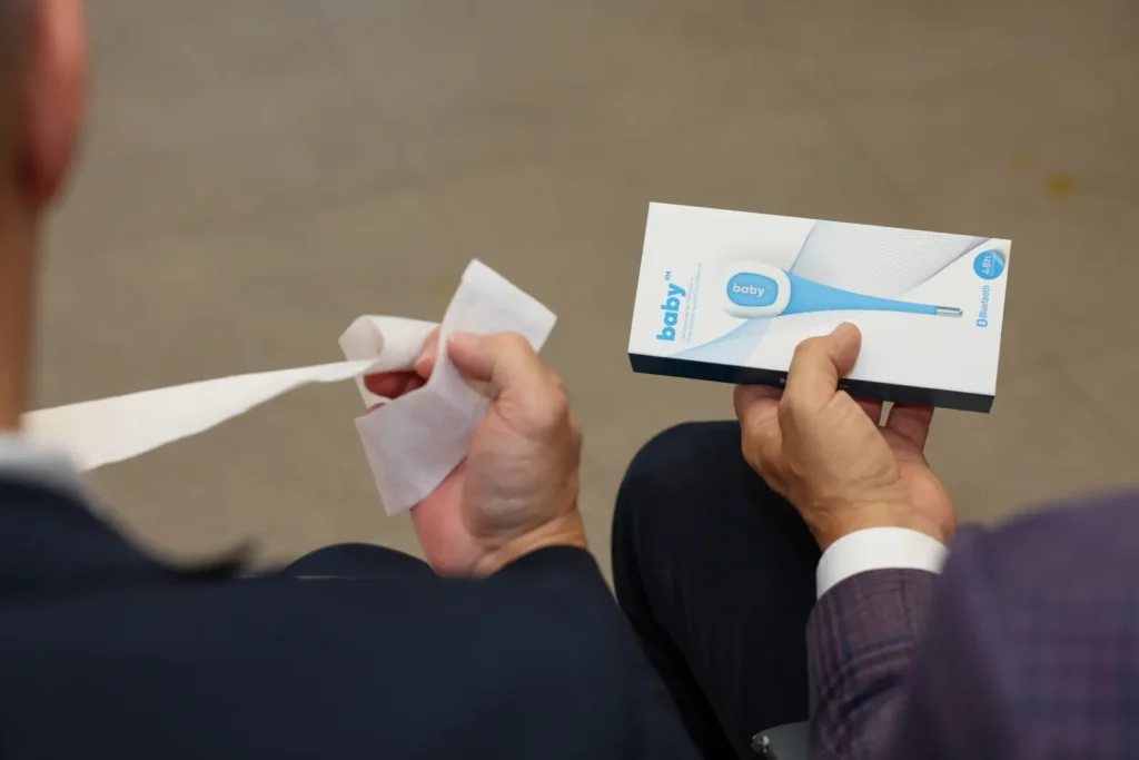 Baby FM wearable temperature sensor box held by a member of the Swiss delegation